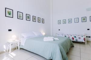 Postel nebo postele na pokoji v ubytování Pangea e Panthálassa B&B