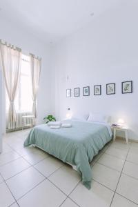Postel nebo postele na pokoji v ubytování Pangea e Panthálassa B&B