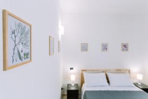 Postel nebo postele na pokoji v ubytování Pangea e Panthálassa B&B