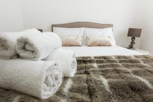 a bedroom with a bed with towels on it at Orion Marina Sea View - Parking - by Brighton Holiday Lets in Brighton & Hove +13 photos