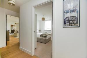 a living room with a bed and a mirror at Orion Marina Sea View - Parking - by Brighton Holiday Lets in Brighton & Hove