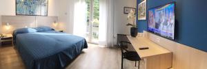 Postel nebo postele na pokoji v ubytování Hotel Garibaldi