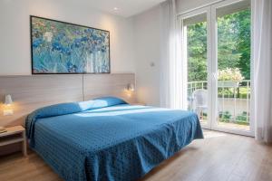 Postel nebo postele na pokoji v ubytování Hotel Garibaldi
