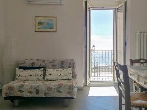 a living room with a couch and a balcony at LA FINESTRA SUL MARE in Ortona