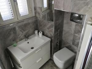 a bathroom with a sink and a toilet at LA FINESTRA SUL MARE in Ortona +15 photos