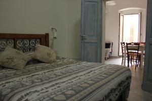 a bedroom with a bed and a table and chairs at LA FINESTRA SUL MARE in Ortona
