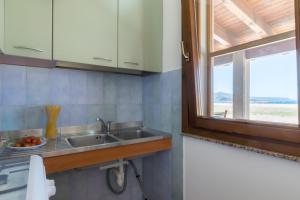 a kitchen with a sink and a window at Residenza Solemar in Bosa Marina +52 photos