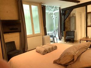 a bedroom with a bed with two towels on it at Lovely studio Le Marais in Paris