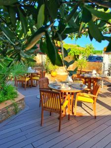 a group of tables and chairs on a patio at Hôtel Beau Soleil in Le Lavandou