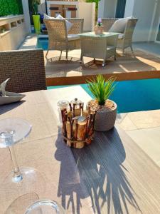 a table with a basket of plants on top of it at Hôtel Beau Soleil in Le Lavandou
