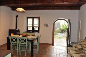 a kitchen with a table and chairs in a room at Apartmaji Kumar in Šmartno