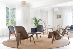 a living room with chairs and a table at Boutique Hotel Oriola in Cala de Sant Vicenc