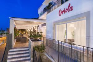 a balcony of a hotel with a store at Boutique Hotel Oriola in Cala de Sant Vicenc