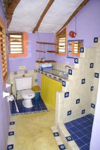 a bathroom with a sink and a toilet in it at Casa Cereza in Holbox Island