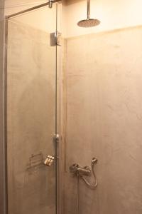 a shower with a glass door in a bathroom at Athens Blossom House under Acropolis with private entrance in Athens