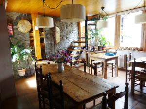 a dining room with a wooden table and chairs at Hostal Casa Laplaza in San Juan de Plan