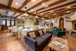 a living room with a couch and tables and chairs at Ciudad de Jaca in Jaca