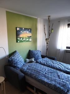 a bedroom with a bed and a couch at Ferienwohnung Vogelvilla in Altenbeken