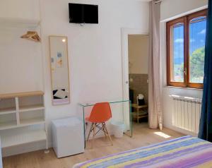 a bedroom with a bed and a glass table at Mondello Beach Rooms - by the sea in Mondello