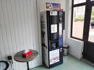 a vending machine with a small table next to a window at Casa Grande in Eforie Nord