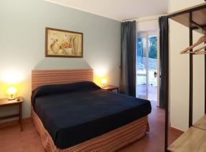 Letto o letti in una camera di Dimora Villa Serena Porto Selvaggio
