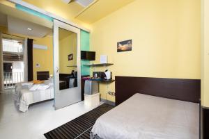 a hotel room with a bed and a television at Chiaia Relax in Naples