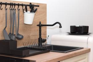 a kitchen counter with a sink and utensils at Apartmani Španja in Vodice +80 photos