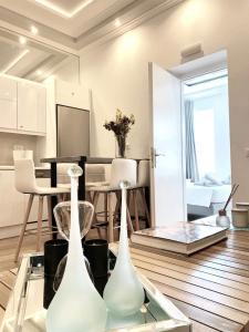 a living room with a dining room table and chairs at Luxury apartment in the heart of Mykonos town in Mýkonos City