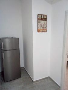 a refrigerator in a room with a sign on the wall at Tara Deluxe Apartment in Budva