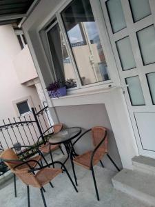 a balcony with two chairs and a table and a window at Tara Deluxe Apartment in Budva