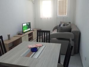 a living room with a table and a couch at Apartman Jevtić 1 in Gornja Toplica +1 photo