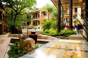 a courtyard with a vase in the middle of a building at Casa de Adobe Gallery & Luxury Boutique in Oaxaca City