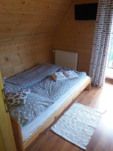 a bedroom with a bed in a wooden cabin at Sebahouse in Zakopane