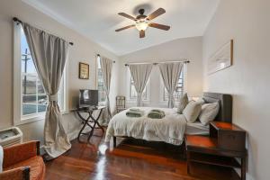 a bedroom with a bed and a ceiling fan at Freret Apartments near Streetcar & Tulane in New Orleans