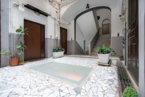 a courtyard with a pool in the middle of a building at Chiaia Relax in Naples