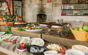 a buffet table filled with lots of different types of food at Panoramic Cave Hotel in Göreme