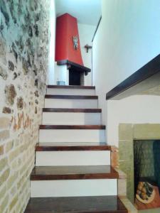 a staircase in a house with a fireplace at Casa Lombardi in Ovindoli