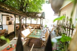 an outdoor patio with a table and chairs at Hotel Weiß in Munderfing