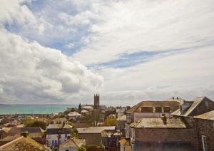 a view of a city with the ocean and buildings at Union Hotel in Penzance