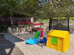 a playground with a play set and a swing at Rodnoy Prichal Guest House in Arkhipo-Osipovka