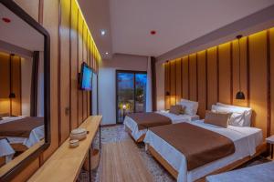 Postel nebo postele na pokoji v ubytování Arwen Hotel