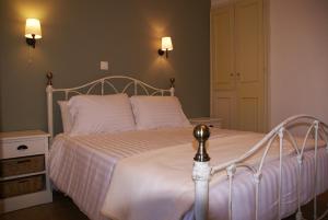 a bedroom with a white bed with two pillows at Thalero Holidays Center in Lygia