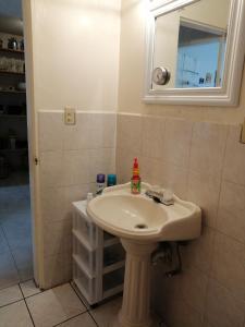 a bathroom with a sink and a mirror at Pied-à-Terre Center of Tijuana in Tijuana