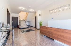 a living room with a staircase in the background at Lilu Apartamenty in Dziwnów