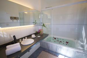 a bathroom with a sink and a shower at Pousada Vivenda in Tiradentes