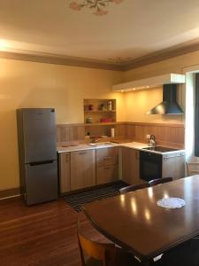 a kitchen with a table and a refrigerator at Villa Emilia in Craveggia