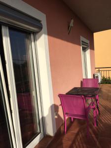 a purple table and chairs on a patio with a window at Villa Mirjana in Dramalj