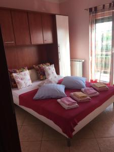 a large bed with towels and pillows on it at Villa Mirjana in Dramalj