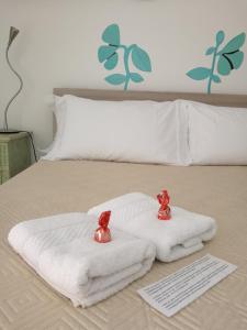 a bed with two towels on top of it at Camera Privata in Pomezia