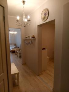a room with a hallway with a clock on the wall at Maza Venecija-Kuldiga in Kuldīga